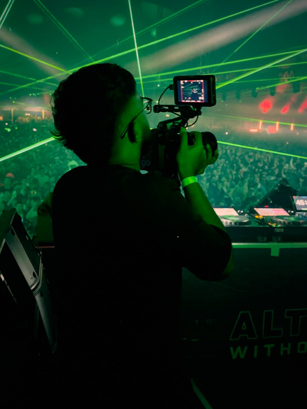 Ethan filming side-stage under green lasers